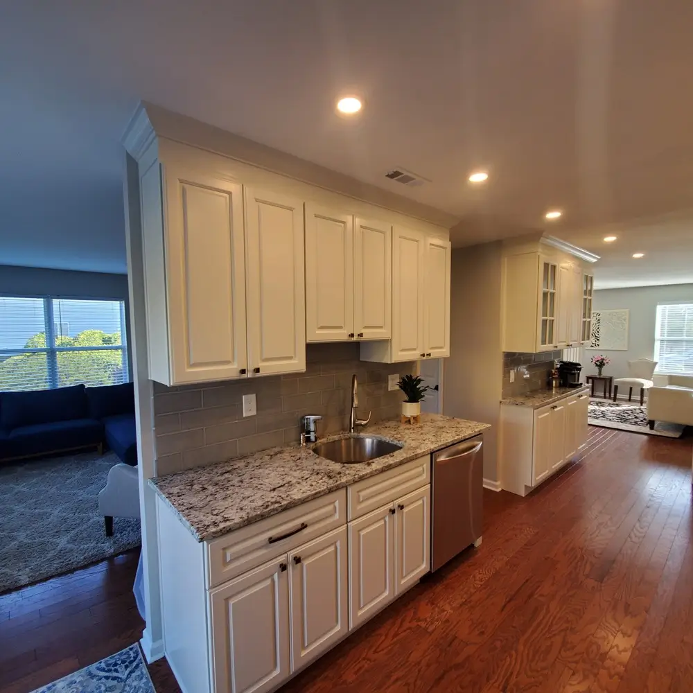 Open kitchen with light cabinets and view to the living room