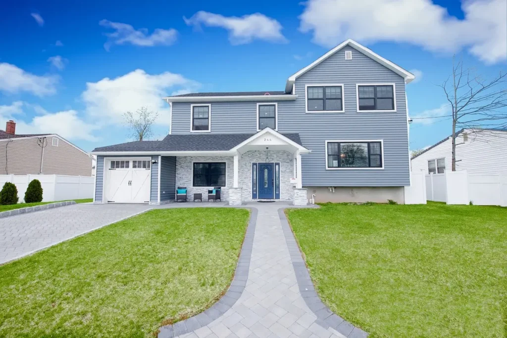 Charming house front with a well-maintained green lawn.