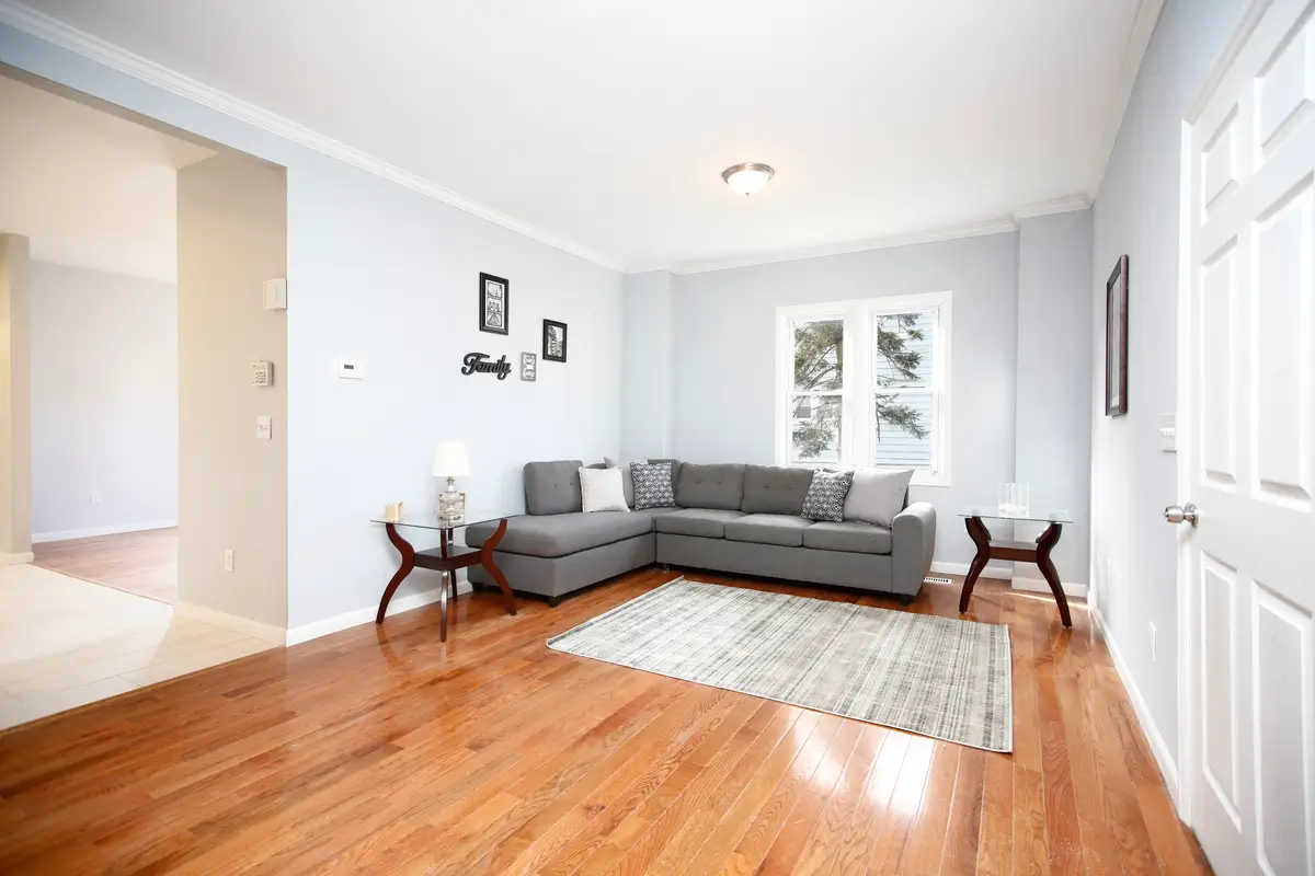 Modern living room with gray sofa and wooden floor