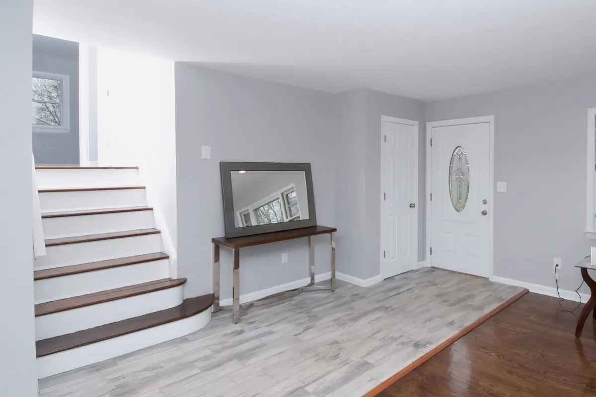 Bright entrance with wooden staircase