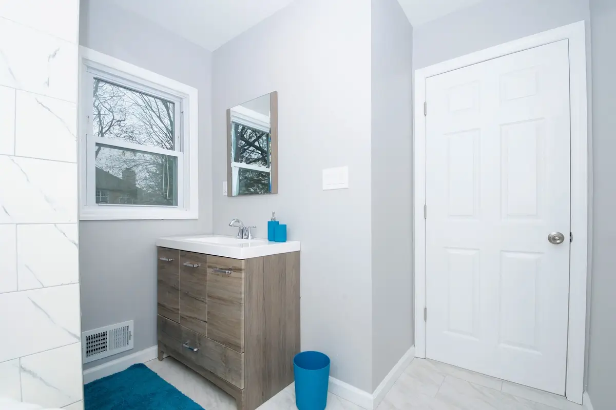 Compact bathroom with wooden vanity
