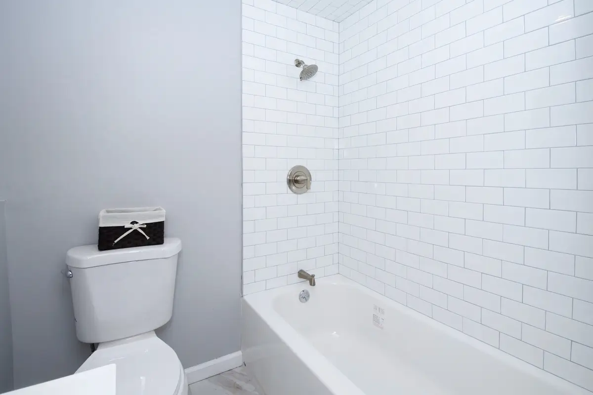 Simple bathroom with white tiled bathtub