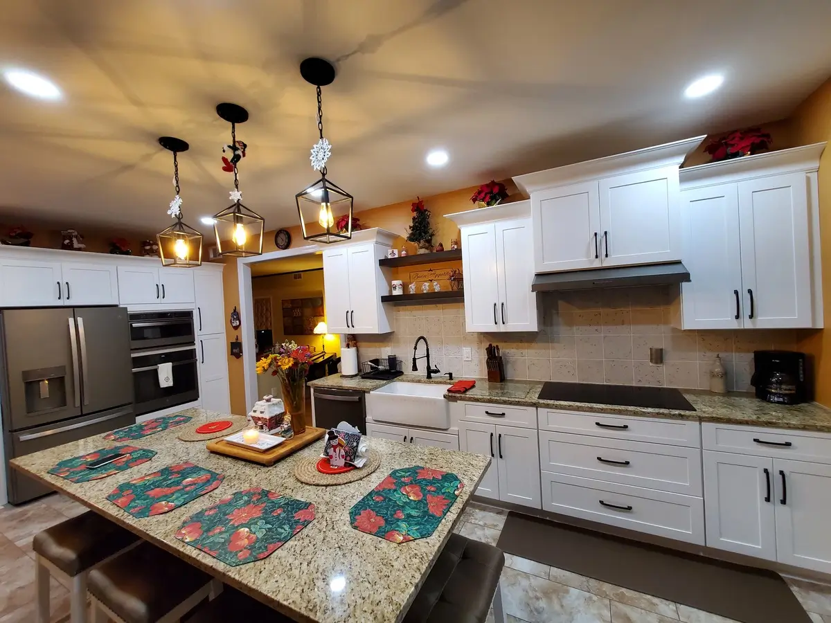Ceramic kitchen with granite counter tops and white cabinets