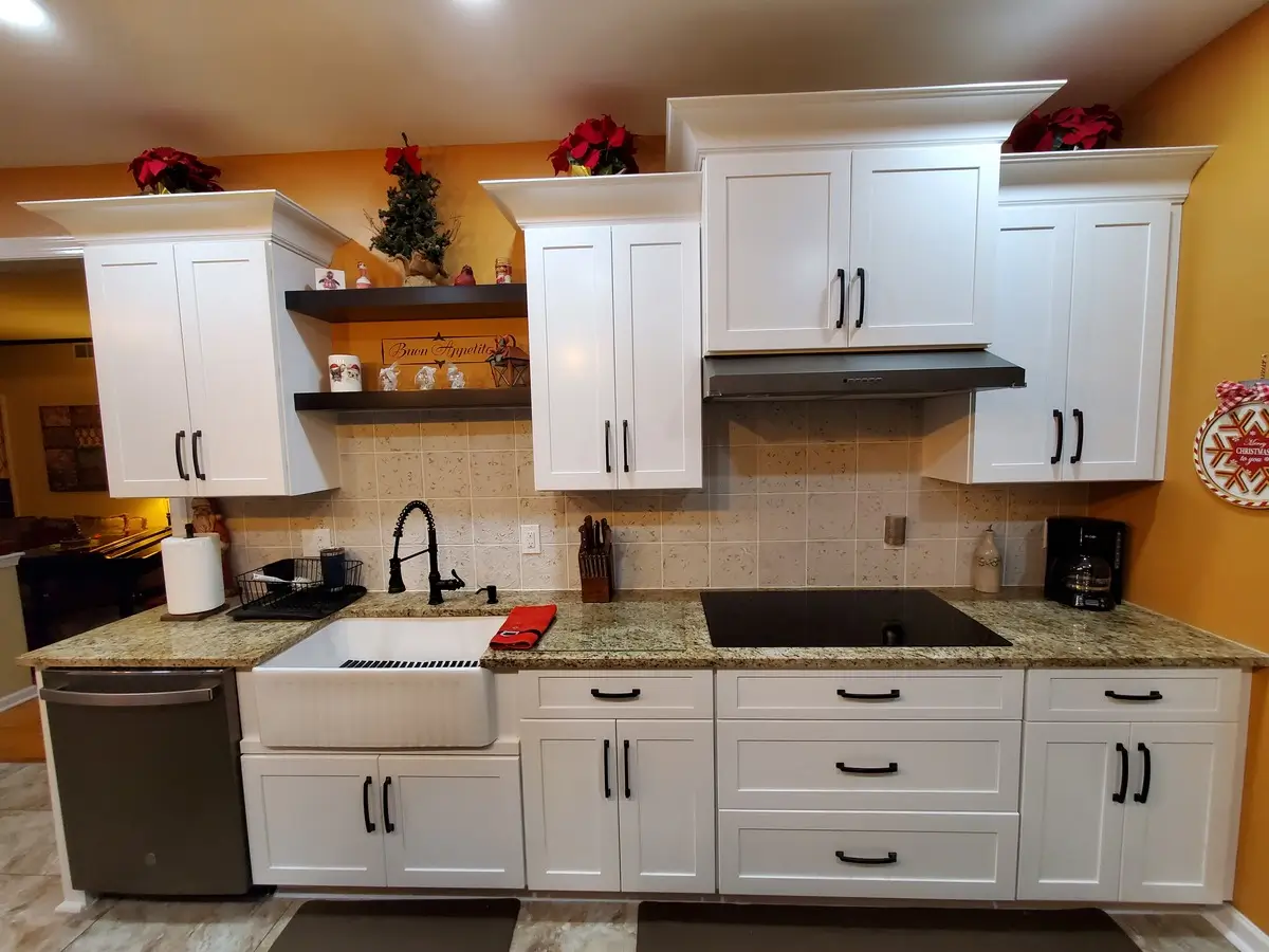 Ceramic kitchen with granite counter tops and white cabinets