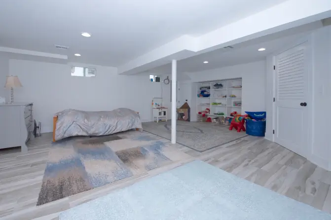 Modern basement room with bed and play area