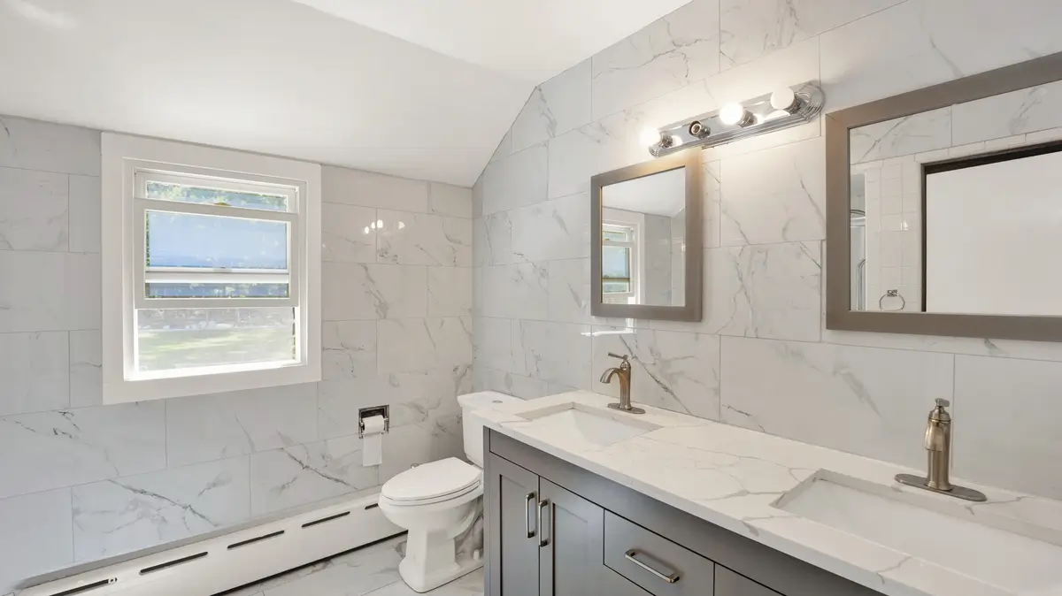 Modern bathroom with white Calacatta marble and double sinks