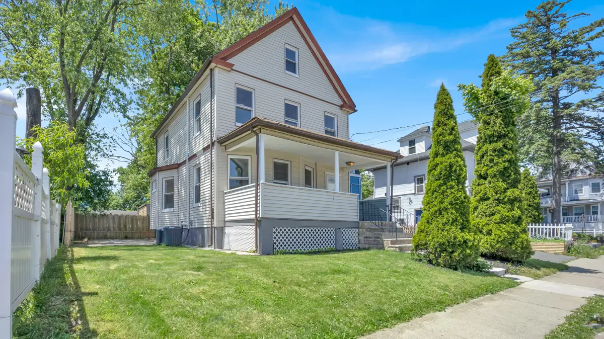 Two-story house with covered front porch and garden