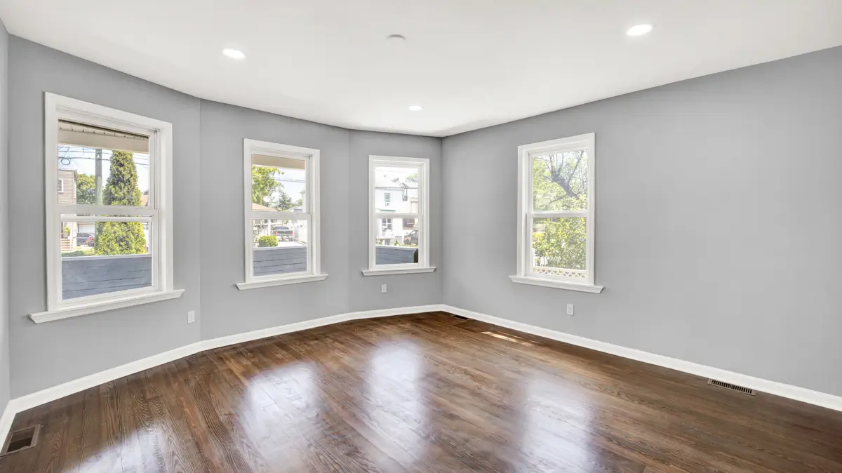 Open space with wooden floor and gray walls.