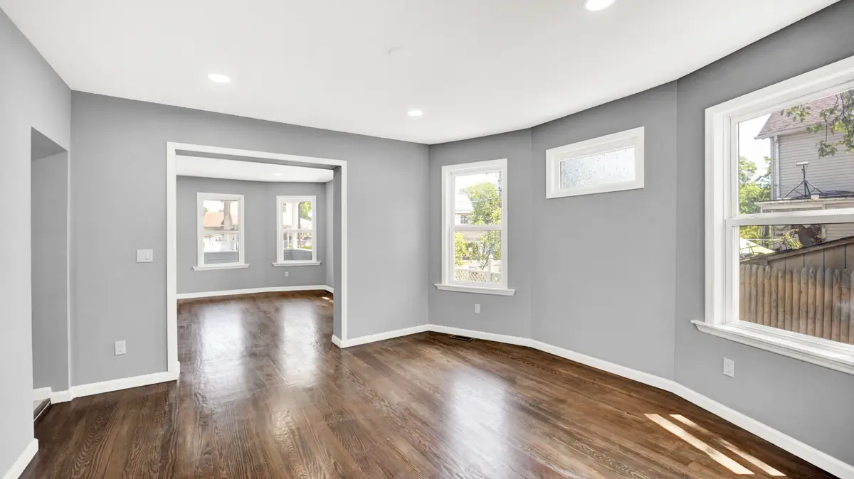 Open space with wooden floor and gray walls.
