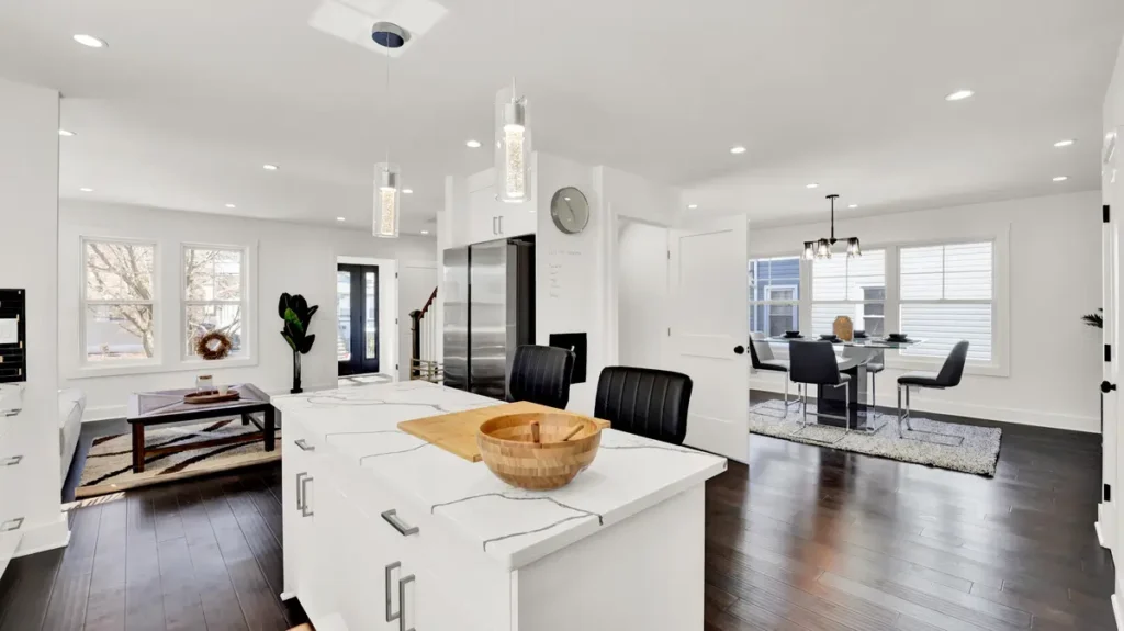 Kitchen and dining room with white cabinets and a large island
