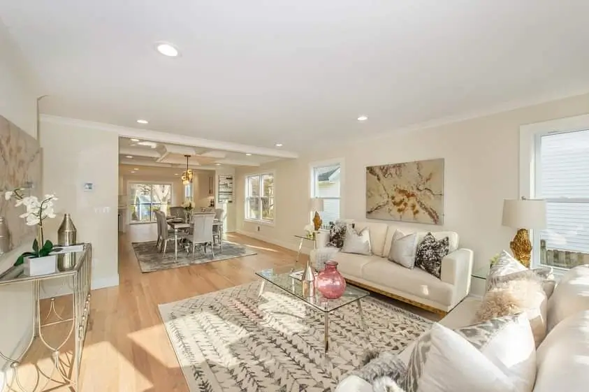 Open plan living room with white sofas and patterned rug